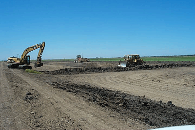 bulldozer and backhoe moving and clearing dirt