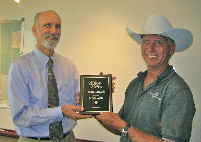 CalSierra Construction's Randy Waite smiles at the camera while accepting the Big Hat Award and wearing a white stetson